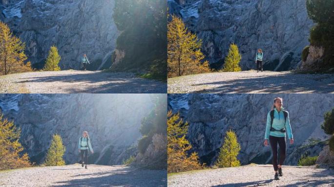 健康的女运动员保持健康的生活方式，在周围风景优美的山区徒步旅行