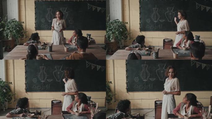 妇女在陶艺课上教孩子