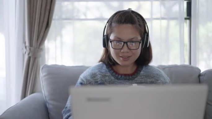成熟的女人在家用笔记本电脑工作