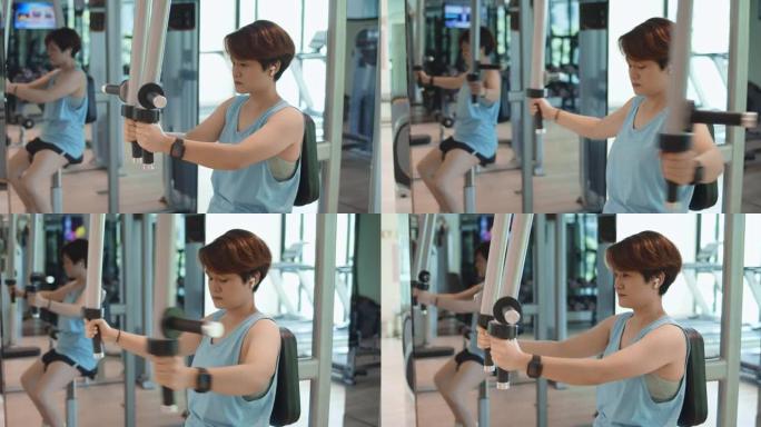 SLO MO健身女子在健身房用健身器执行锻炼，多莉射击