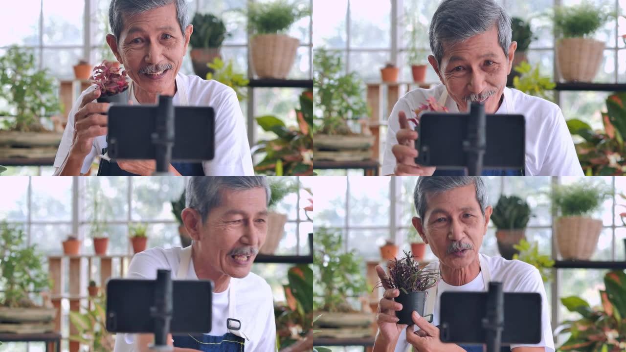 62岁的自信亚洲资深男子在视频博客的镜头前讲话。一名老人一边写博客，一边在家中的社交媒体上直播视频，