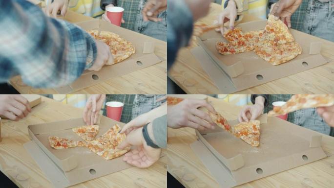 当商人在办公室吃饭时，男性和女性的手在吃披萨的特写镜头