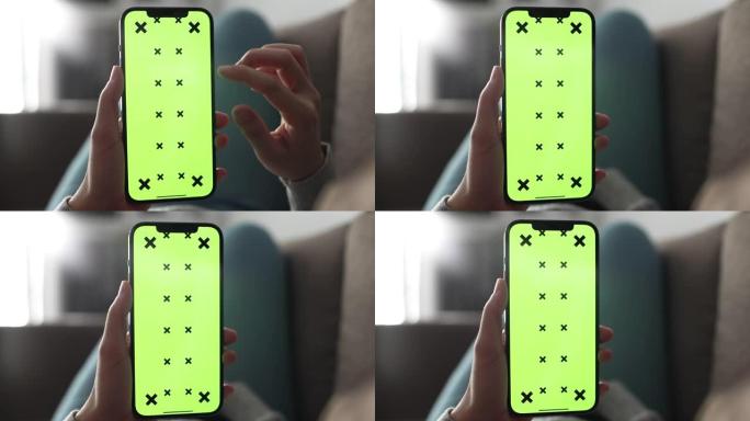 使用绿屏智能手机的特写女人手