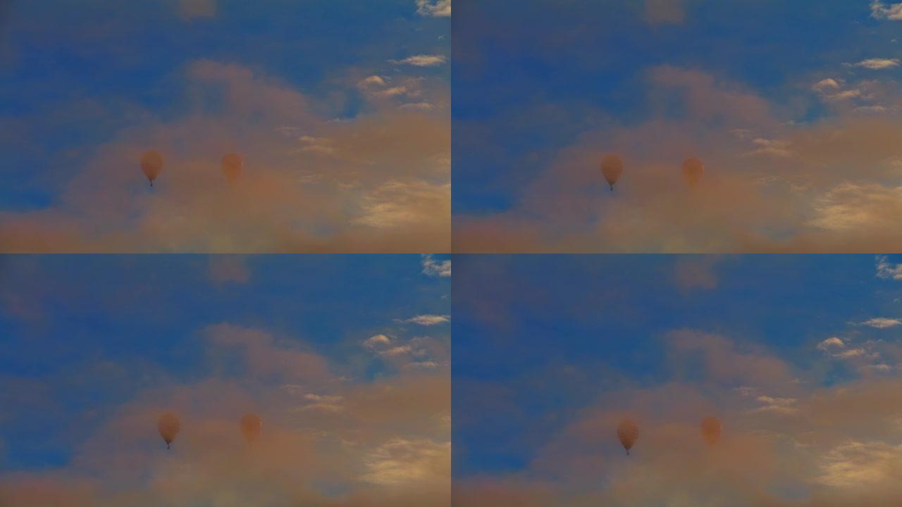 在蓝天中漂浮在空灵云层后面的热气球