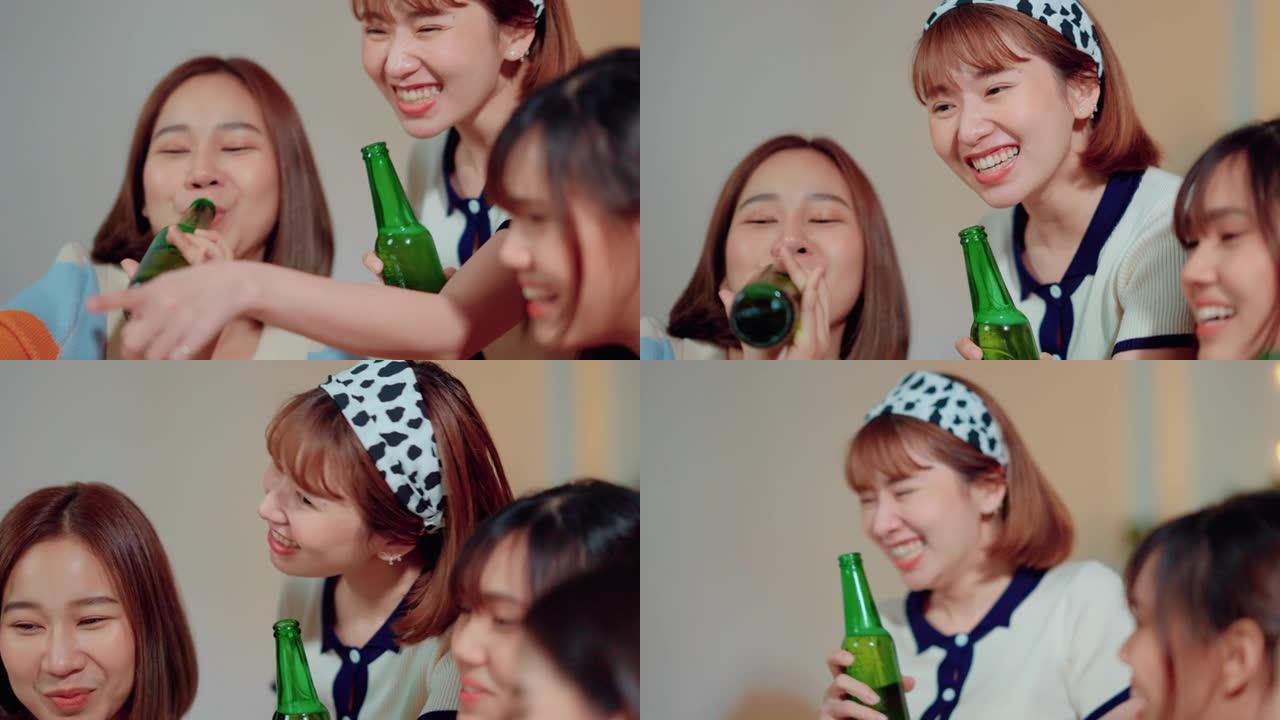 年轻的亚洲妇女在私人聚会上喝酒和吃零食时自拍后看着照片。