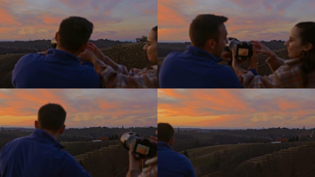 夫妇在日落时拍摄风景秀丽的山景