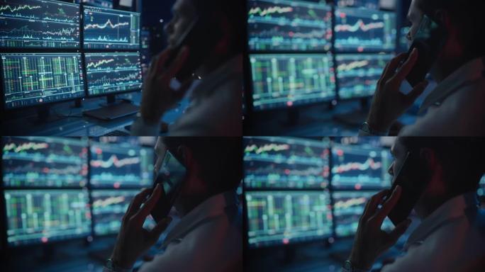 金融日交易员在深夜办公时，在一台带有实时股票图表的多显示器工作站的计算机上工作，并与客户通电话。关闭