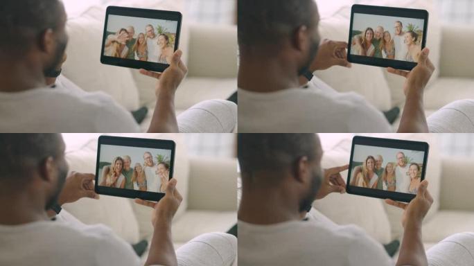 后视图，非洲民族的快乐年轻人坐在家里放松与五个朋友进行视频通话，一群朋友通过平板电脑在户外度假期间使