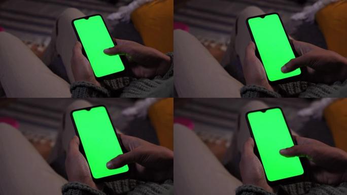 男人在家在手机绿屏上滚动拇指