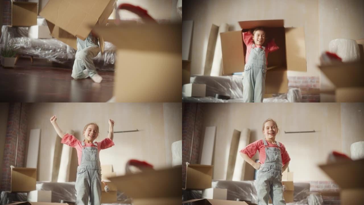 小女孩的肖像玩捉迷藏从纸箱里跳出来，玩捉迷藏。快乐的孩子在公寓客厅玩得开心。快乐，大笑，可爱的孩子享