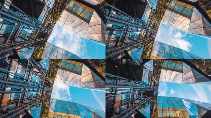 高层企业建筑摩天大楼的延时低角度，高层建筑与建筑中心的玻璃电梯之间的云反射
