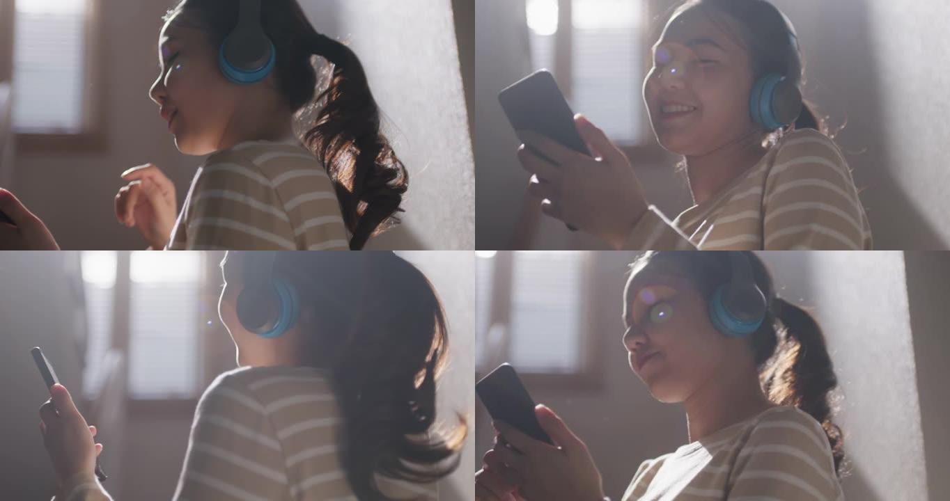 年轻的亚洲女人听音乐播客手机舞蹈享受家。