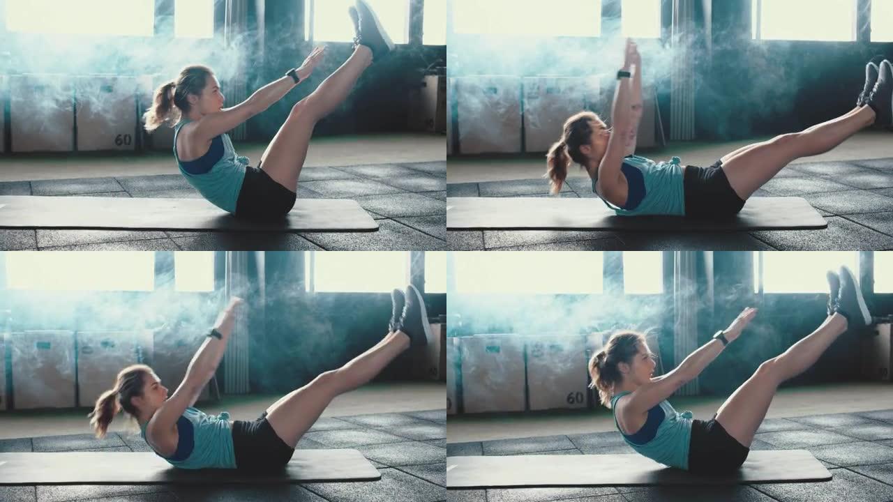 侧视图自我隔离锻炼。迷人的运动年轻女子在大气健身房的瑜伽垫上进行剧烈的腹肌运动