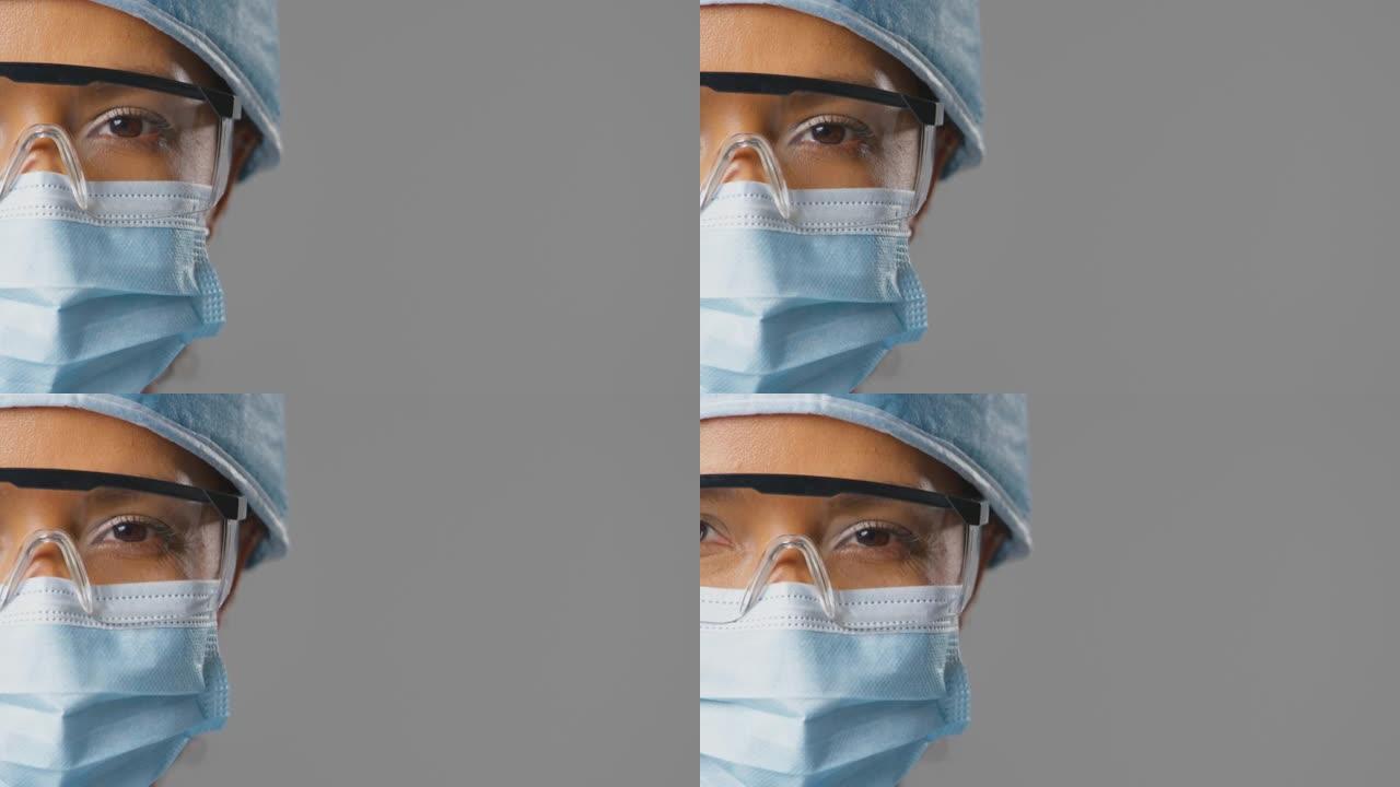 特写工作室女外科医生的肖像，戴着安全眼镜，戴着磨砂膏和口罩