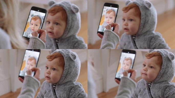 母亲用智能手机给婴儿拍照，享受在社交媒体上分享母亲生活方式的可爱幼儿拍照