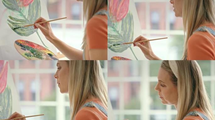 一位女画家的特写镜头集中在工作室的画布上。在工作室做艺术治疗自然艺术品的女孩。一位富有创造力的女人在