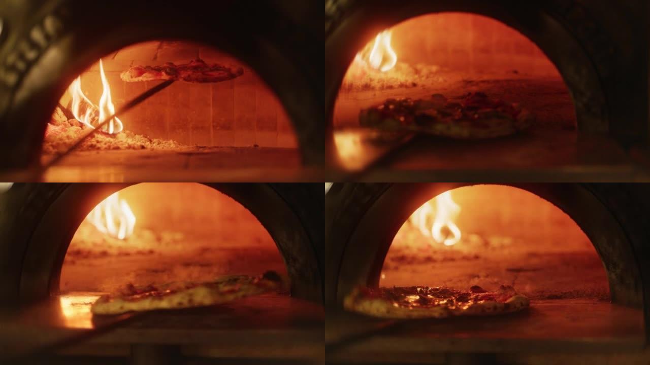 在餐厅披萨去皮，将披萨放入柴火石烤箱中。传统烹饪，意大利家庭食谱。正宗的比萨店，有美味的有机食品。电