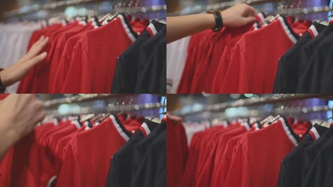 亚洲中国男性手持男装衬衫在服装店选择合适的购物