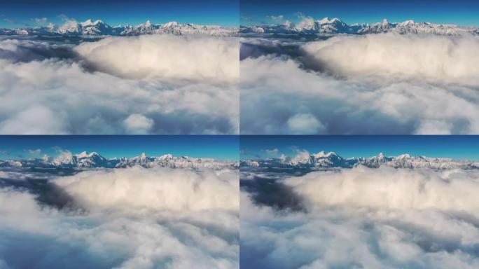 云瀑倾泻在雪山前云海山脉