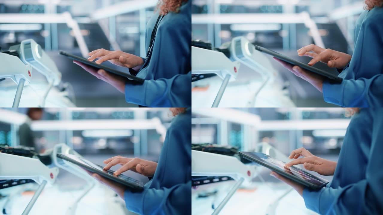 特写一名妇女在高科技现代工业办公设施中使用平板电脑的镜头。工程师在智能设备上编程并设置现代机器人概念