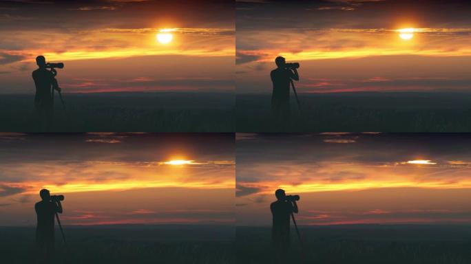 男人在美丽的日落背景下使用带三脚架的相机