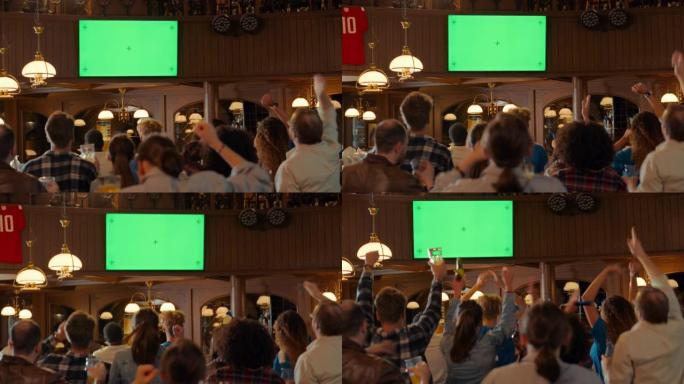 一群多元文化的朋友在酒吧里观看电视直播体育比赛，绿屏显示。快乐的球迷欢呼和喊叫，庆祝球队进球并赢得比