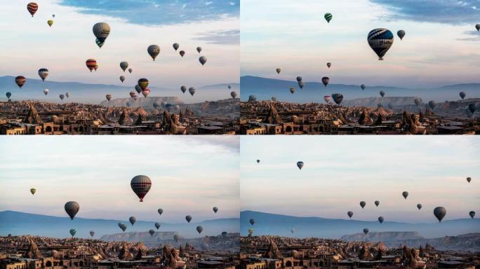 日出时热气球飞越卡帕多西亚山谷。空中无人机的观点。戏剧性的晨光