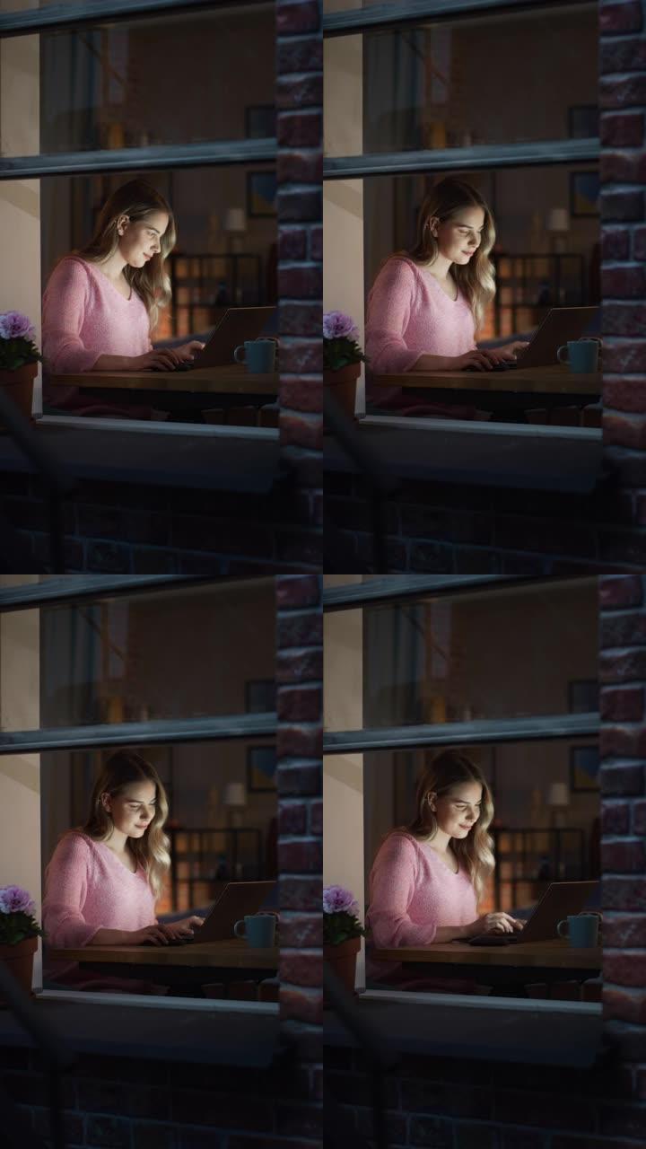 垂直镜头: 美丽的白人女人晚上在家用笔记本电脑工作。年轻的女性媒体关系经理制定品牌创新战略并在线与同