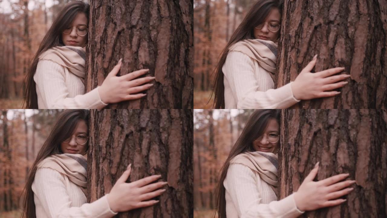 公园里拥抱树的快乐年轻女子