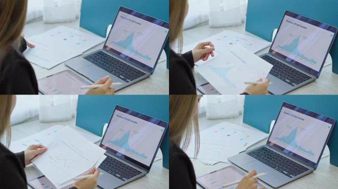 女商人在电脑屏幕和平板电脑上进行数据分析。后视图。