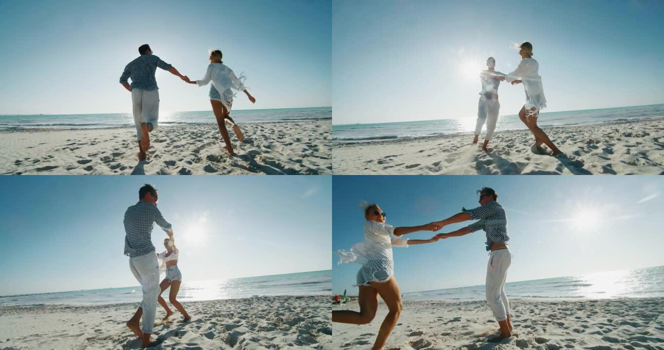 年轻无忧无虑的夫妇的慢动作在阳光明媚的日子里，在海边的海滩上玩得很开心，一起享受他们的暑假。