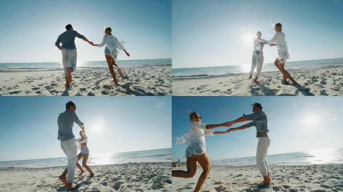年轻无忧无虑的夫妇的慢动作在阳光明媚的日子里，在海边的海滩上玩得很开心，一起享受他们的暑假。
