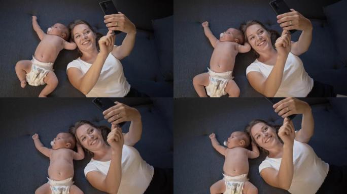 SLO MO深情的年轻母亲为自己和婴儿自拍