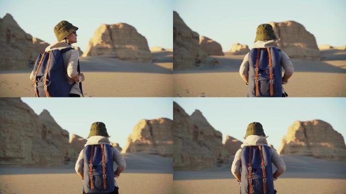 亚洲女性背包客与雅丹地貌一起在戈壁沙漠行走