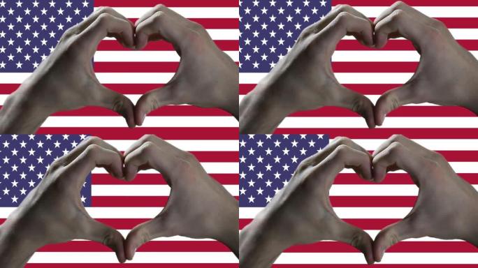 做心脏手标志和美国国旗的人。