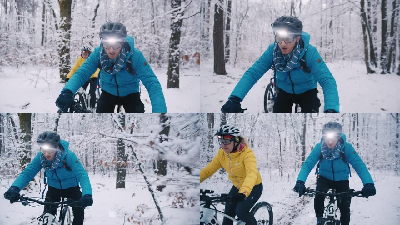 在下雪的冬季小径上与前灯骑行ebikes的情侣