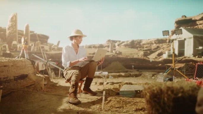 考古挖掘现场盘古: 美丽的女考古学家做研究，用笔记本电脑，分析出土的古代文明文化文物。发掘现场的伟大