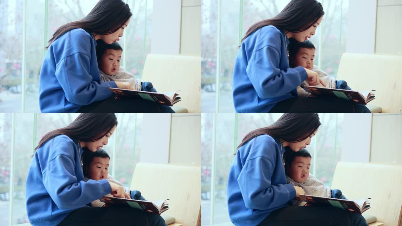 母亲带着儿子看书妈妈陪孩子看书视频素材