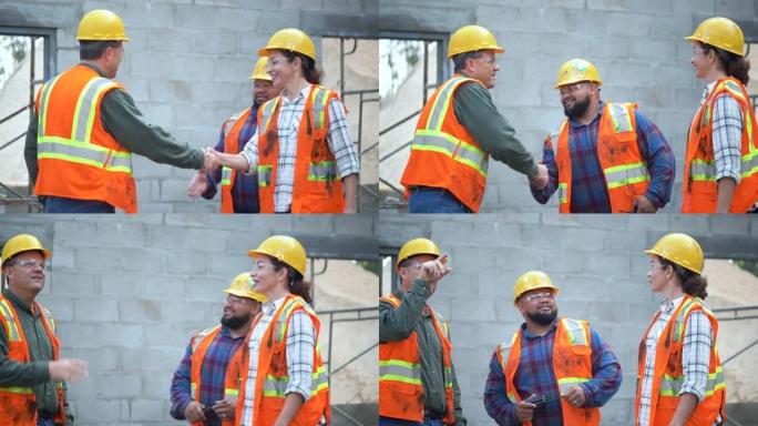 多民族工人在建筑工地握手
