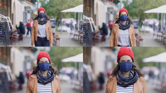 城市人行道上戴着面具的女性