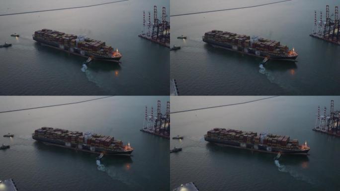 集装箱船的鸟瞰图将货物运送到大洋上，而物流进出口和运输业则在深夜工作。运输/工业，夜班概念