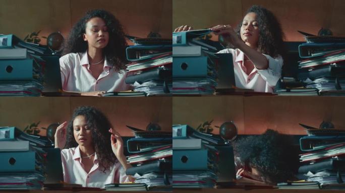 文书工作程序疲惫忙碌的年轻混血会计女商人在家里的桌子上工作，在成堆的文件中。