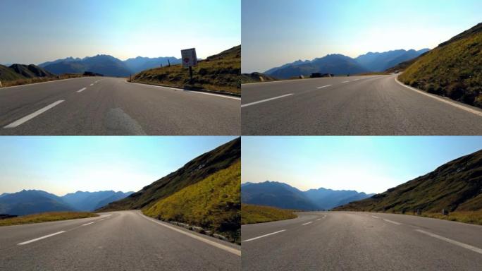 汽车司机在蜿蜒的山路上享受汽车骑行，第一人称视角