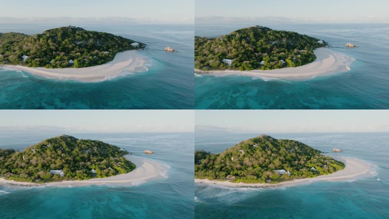 塞舌尔库锡岛上豪华度假胜地的特写空中平移视图，带有太阳能农场，别墅和私人海滩