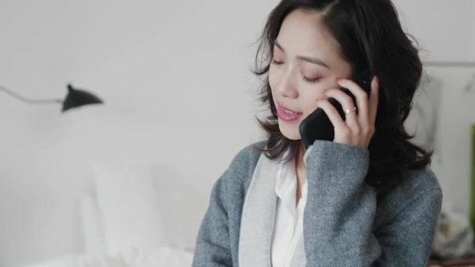 美丽的亚洲女商人在电话里聊天