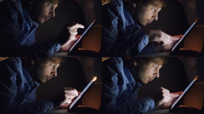 一个年轻商人晚上在家使用数字平板电脑的4k视频片段