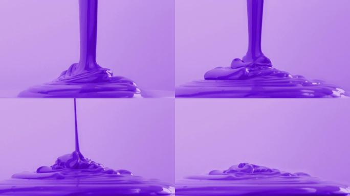 紫色油漆倒出用于艺术或DIY