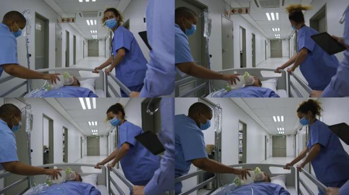 医院走廊上戴着口罩的女性医生在床上推病人