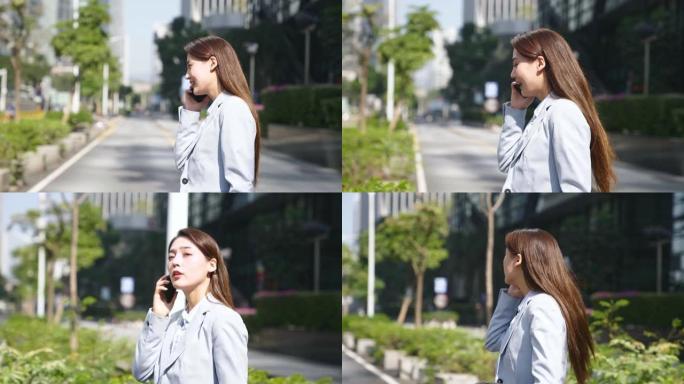 年轻的亚洲女商人在街上散步时用手机聊天