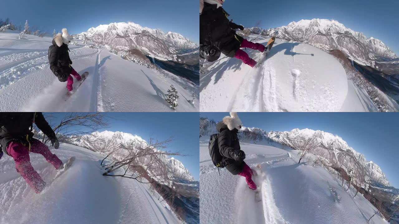 在阳光明媚的日子里，年轻女子在新鲜的粉末雪中滑雪下山